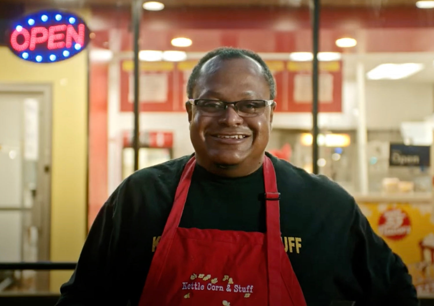 Founder Keith Jackson smiling in front of the retail storefront for Keith's Kettle Corn